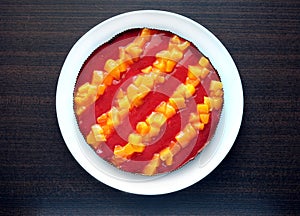 Still life with appetizing sweet cake with stripes from pineapple pieces on wooden table