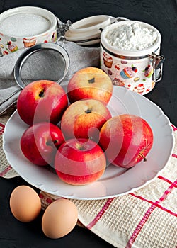 still life with apples spread out on a plate kitchen towel and flour