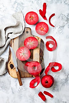 Still life with apples on wooden board over white marble table, top view. Fresh red apples Baya Marisa. photo