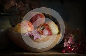 Still life with applles and scarlet viburnum autumn branches and berries in vintage style