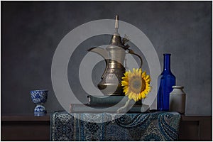 Still life Arabic coffee pot sunflower and bottles