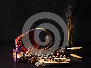 Still life arrangement with candlelight, spread peanuts, nuts, and lavender.