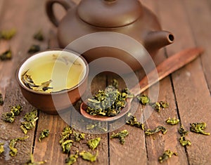 Still life with asian tea set and raw tea leaves 1