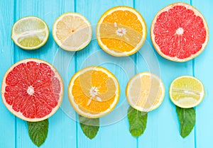 Still life of assorted halved fresh citrus fruit