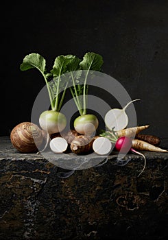 Still Life of Assorted Root Vegetables on Dark Surface