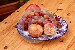 Still life of autumn fruits, with apples, grapes and pomegranate