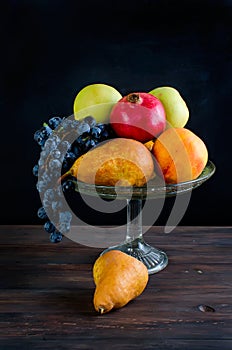 Fresh autumn fruits - pomegranate, pears, grapes and apples