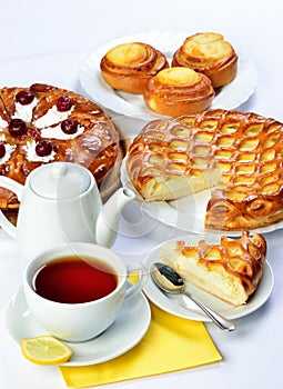 Still life with baking pies and tee cup and pot.