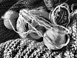 Still life of balls of yarn, woolen and acrylic threads, knitting needles, knitted products. Soft light from the window. Knitting