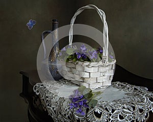 Still life with a basket of violets