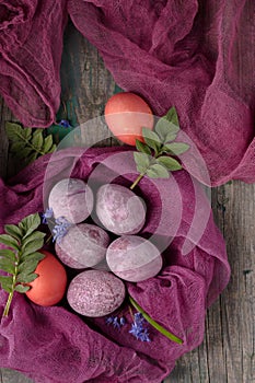 Still life of beautiful textured purple eggs on purple gauze