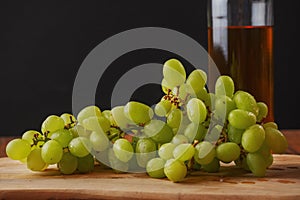 Still life with big cluster of white juicy grapes