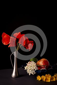 Still life on a black background. A bouquet of wild red poppies.