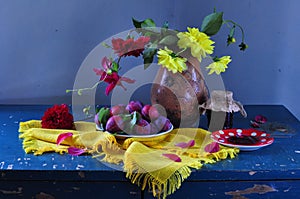 still life with blue plums and flowers