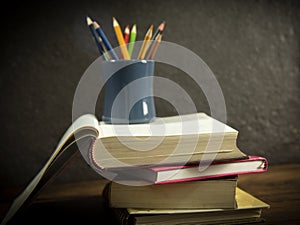 Still life book in library with pencils colour in pencil case on dark background education concept back to school