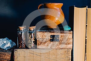 Still life of books, bottles with spices and semi precious stone