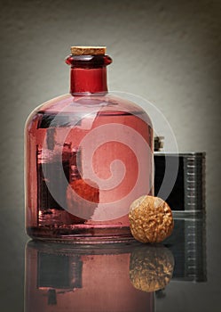 Still life with bottle and walnut