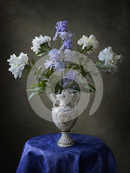 Still life with bouquet of irises and peonies