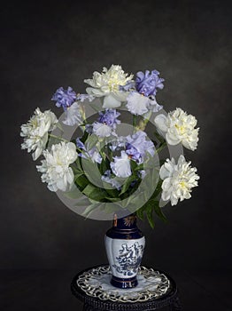 Still life with bouquet of irises and peonies