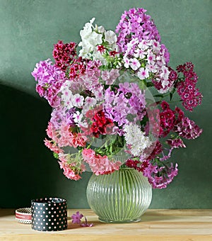 Still life with bouquet of pink Phlox in the clear jug