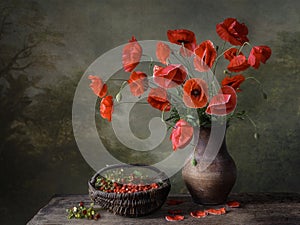 Still life with bouquet of red poppies and strawberry