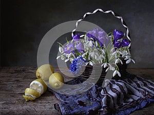 Still life with bouquet of spring flowers and lemons