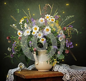Still life with a bouquet of Transvaal daisies in a white jug.