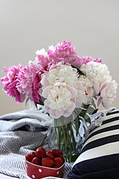 a still life with a bouquet of white and pink peonies and strawberries