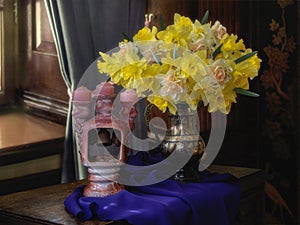 Still life with bouquet of yellow daffodils and candlestick