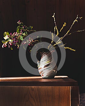 Still life with a branch of berries and a dry branch.