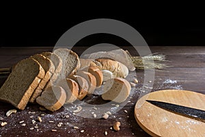 Still life with bread and wheat on wooden table