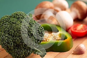 Still life of broccoli, slice of green bell pepper, tomato