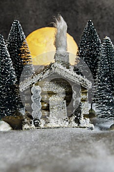 Still life cabin in snowy woods with full moon