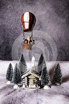 Still life cabin in snowy woods with Santa Claus overhead