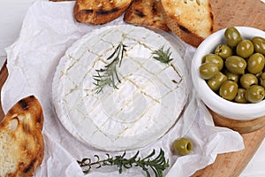 Still life with camembert and baguette. Camembert with grilled baguette