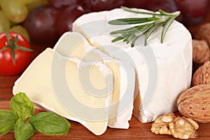 Still life with Camembert cheese cut on slices photo