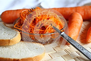 Still life: carrot salad with white loaf