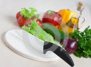 Still life with ceramic knife and vegetables