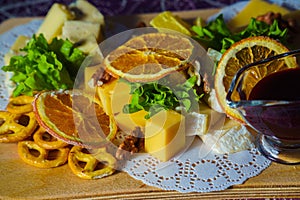 Still life of cheese and dried orange as an appetizer for wine