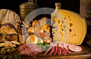 Still life with cheese, italian salami, different types of bread, olives, etc.