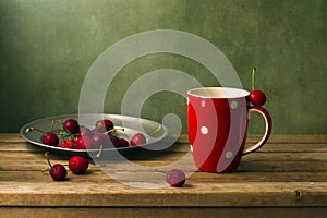 Still life with cherries and red cup