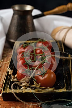 still life. cherry tomato branch, bread, fork