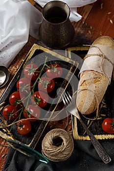 Still life. cherry tomato branch, bread, fork