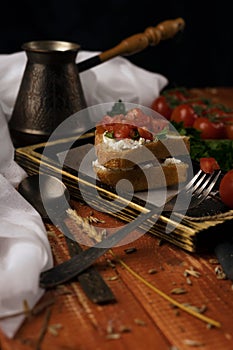 Still life, cherry tomato branch, bread, fork