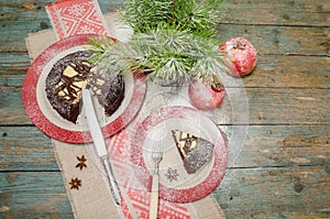 Still life with chocolate cake, Christmas tree and pomegranate