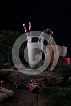 still life Christmas milk on a wooden table with Christmas decorations on a dark background