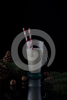 still life Christmas milk on a wooden table with Christmas decorations on a dark background