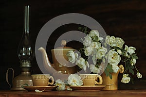 Still-life clay coffee cups with fresh white roses