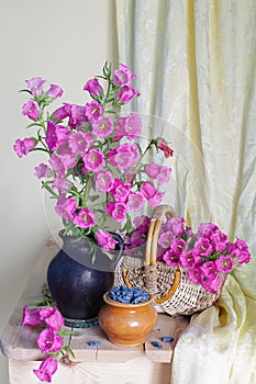 Still life with clay jug and kettle  Cup and basket with embroidered flower towel