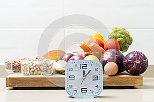 Still life with a clock and healthy food